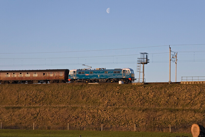 86259, outward leg of The Cumbrian Mountain Express 2, 07.06 London Euston-Carlisle (1Z86), Whilton Locks SP619640 
 A side-on view of the outward leg of The Cumbrian Mountain Express passing along the top of a lofty embankment between Weedon and Whilton in Northamptonshire led by veteran AL6 86259 'Les Ross/Peter Pan'. I chose this interesting view in part due to the third-quarter phased moon above the locomotive. Leaving London Euston at 07.06 and running as 1Z86 it arrived on-time into Preston and 10.16 where 60009 'Union of South Africa' took over for the rest of the outward leg to Carlisle with a legendary accent of Shap. 
 Keywords: 86 259 The Cumbrian Mountain Express 2 07.06 London Euston-Carlisle 1Z86 Whilton Locks SP619640 Les Ross Peter Pan AL6