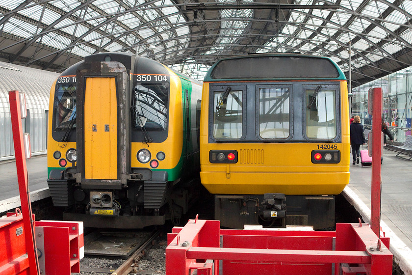 350104, LM 13.04 Liverpool Lime Street-Birmingham New Street & 142045, NT 13.27-Liverpool Lime Street-Manchester Oxford Road (2H40), Liverpool Lime Street station 
 Two very different faces at Lime Street station. To the left is London Midland's 350104 waiting to leave with the 13.04 Liverpool Lime Street to Birmingham New Street. To the right is Northern's ageing Pacer, 142045 itself waiting to leave at 13.27 for Manchester Oxford Road. 
 Keywords: 350104 13.04 Liverpool Lime Street-Birmingham New Street 142045 13.27-Liverpool Lime Street-Manchester Oxford Road 2H40 Liverpool Lime Street station