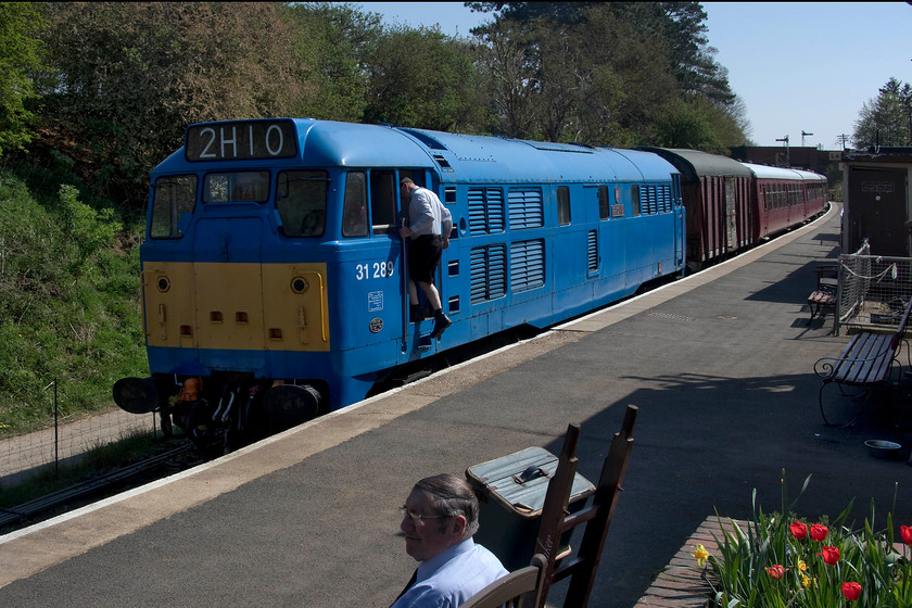 31289, 13.00 Pitsford return, Pitsford & Brampton station 
 Having got the right away from the guard, the driver climbs aboard 31289 'Phoenix' ready to get the 'Easter egg' 13.00 Pitsford return working away from Pitsford and Brampton station. The class 31 may well be wearing an unorthodox livery but at least it is in better condition now than the rusty hulk it was for a number of years. 
 Keywords: 31289 13.00 Pitsford return Pitsford & Brampton station