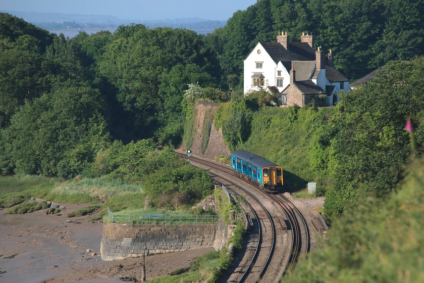 150213, AW 07.07 Cardiff Central-Cheltenham Spa (2G52, RT), Purton SO672049 
 150213 makes its way along by the side of of the Severn Estuary working the 07.07 Cardiff Central to Cheltenham 2G52 service, it is seen passing the village of Purton in Gloucestershire. The substantial house dominating the scene is Purton Manor that offers superb views across the estuary and of the line. 
 Keywords: 150213 2G52 Purton SO672049