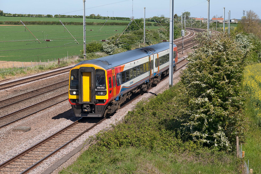 158012, EM 06.47 Liverpool Lime Street-Norwich (1L05, 3L), Swayfield SK994231 
 The village of Swayfiled is approximately two-thirds of the way up Stoke Bank from the south in a very quiet area of east Lincolnshire. The bucolic peace and quiet are periodically broken by passing trains on the ECML such as 158012 working the 06.47 Liverpool Lime Street to Norwich. It is seen in the glorious spring sunshine on the up slow line, however, I was not so lucky with the sun in August 1978 but the subject matter was a whole lot more exciting, see.... https://www.ontheupfast.com/v/photos/21936chg/26818862604/x55015-09-35-hull-london-king-s-cross 
 Keywords: 158012, EM 06.47 Liverpool Lime Street-Norwich (1L05, 3L), Swayfield SK994231