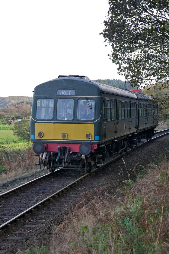 M56352 & M51192, 09.45 Sheringham-Holt, Weybourne woods TG115418 
 M56352 and M51192 work the 09.45 Sheringham to Holt North Norfolk Railway service on the climb to Kelling Heath through Weybourne woods. Despite being the first service train of the day on the popular heritage line and being worked by a diesel unit it appears to be well-patronised testament to the popularity of this line. 
 Keywords: M56352 M51192 09.45 Sheringham-Holt Weybourne woods TG115418 Class 101 DMU North Norfolk Railway