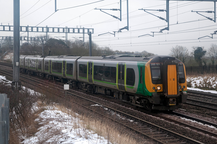 350121, LN 10.24 London Euston-Crewe (1U31, 31E), Ashton Road Bridge 
 Normally, this 4-car class 350 would be on the down fast here approaching Roade on the southern WCML. However, due to engineering works on the Weedon route it is going via Northampton forming the 10.24 London Euston to Crewe. 
 Keywords: 350121 1U31 Ashton Road Bridge