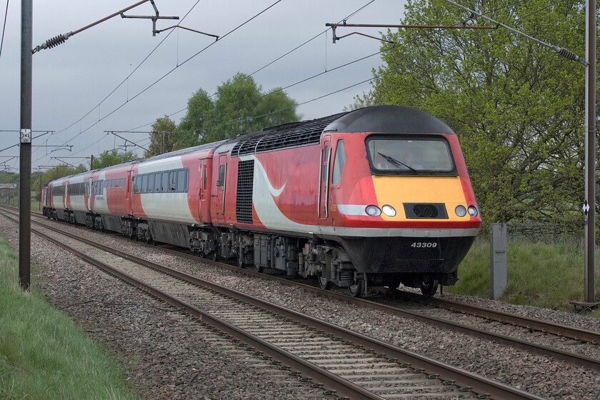 43309 & 43295, 10.49 Neville Hill-Ely Papworth Sidings (RT), Penny's foot crossing SK630970 
 This is what Andy and I had been waiting at Penny's crossing just south of Great Rossington for! Following its retirement from operations on the MML two days previously, (see..... https://www.ontheupfast.com/p/21936chg/30014749310/x43309-18-34-london-st-pancras-leeds) the remnants of set NL58 (43309, 44061, 40750, 42146, 42238 and 43295) head south back on the ECML once again for one last hoorah! Amid a blow on the horn and a wave from the driver the 10.49 Neville Hill to Ely Papworth sidings working makes its way for storage with it having come off lease over the weekend. Notice that staff at the Leeds depot have already been at work removing its temporary EMR branding. The power cars and the stock now face a very uncertain future but I suspect that the cutter's torch beckons sooner than later! 
 Keywords: 43309 43295 10.49 Neville Hill-Ely Papworth Sidings Penny's foot crossing SK630970 EMR HST