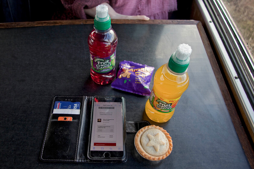 Tickets, mince pie & 'sherry' 
 Technology reaches the Northampton and Lamport Railway but not quite! My wife booked our special event tickets online with them being downloaded to our phones. Unfortunately, the ticket inspector on the train was not at all sure how to deal with this and stated that we should have 'booked in' on our arrival and then came back to double-check that we had actually bought and paid for the tickets! My wife and I enjoyed our snack as part of the ticket price but as I don't drink alcohol and with my wife undertaking dry January the Fruit Shoots were a poor alternative! 
 Keywords: Tickets, mince pie & 'sherry'