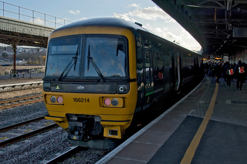 166214, GW 12.43 Great Malvern-Weymouth (2O78, 1E), Bristol Temple Meads station 
 The third and final train of our journey from Northampton to Frome stands at Bristol Temple Meads' platform eleven. The 12.43 Great Malvern to Weymouth service changes direction at Bristol giving me a few minutes to alight and take this photograph at my leisure even if it is rather dark shadows! Whilst the Turbo units were refurbished a few years ago they are a little dated inside and the wi-fi on this particular example was not working making it a little tiresome for a long journey as this unit was undertaking. 
 Keywords: 166214 12.43 Great Malvern-Weymouth 2O78 Bristol Temple Meads station GWR Great Western Railway Turbo