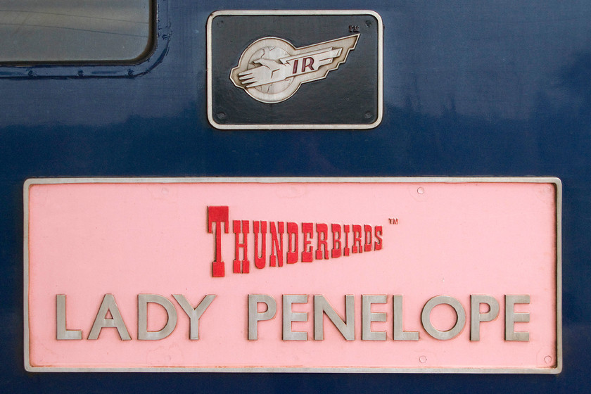 Nameplate, 57307, Rugby station 
 I thought that the nameplate attached to the side of 57307 'Lay Penelope' had faded from red during Virgin days to this rather natty pink. However, I have just found an image on the internet of this Thunderbird locomotive straight after its conversion in 2002 and yes, it had a pink nameplate then. The Class 57 pictured at Rugby between its rescue duties. 
 Keywords: Nameplate 57307, Rugby station Thunderbirds Lady Penelope 47225