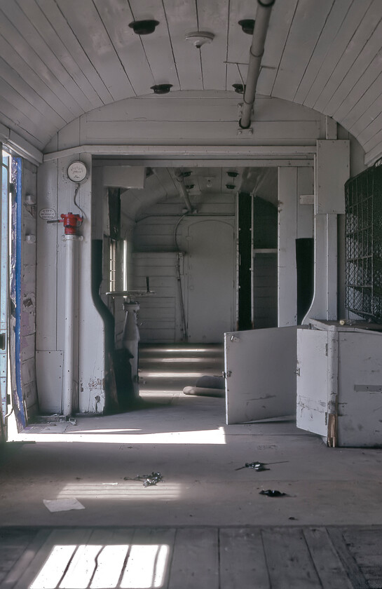 Interior, M31010, Whittlesey 
 Graham and I were able to clamber aboard one of the former LMS vans stored awaiting onward movement and scrapping at Whittlesea. This view inside of M31010 shows its functional and relatively smart interior. Notice the two semi-enclosed areas on opposite sides of the van. These housed a small seat for the guard and access to the ducket or protruding windows that afforded a view along the length of the train that was a notable feature of this design of this van. 
 Keywords: Interior M31010 Whittlesey