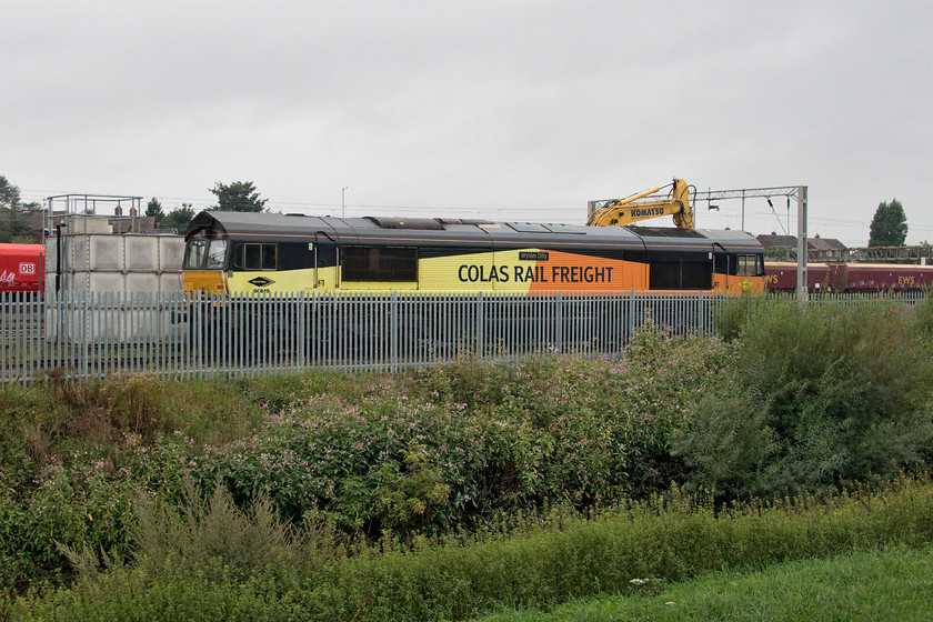 66849, stabled, Bescot yard 
 I had to walk down from Bescot Stadium station to get my only photograph of a Class 66, the rest being much further down out of sight at the southern end. 66849 'Wylam Dilly' awaits its next job in the Colas stabling area. I have only one other photograph of this Class 66 and that was also a poor one taken at Westbury some years ago. Wylam Dilly is now accepted to be the second oldest surviving railway locomotive in the world dating from 1815. It was designed and built by William Hedley and Timothy Hackworth for use in Wylam Colliery and is currently on display at the National Museum of Scotland in Edinburgh. 
 Keywords: 66849 Bescot yard Wylam Dilly Colas Rail Freight