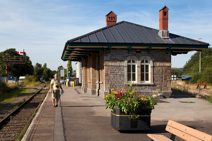 Andy on Pantyffynnon station 
 The delightful pergola style station at Pantyffynnon with Andy standing on the platform that trains traversing the Central Wales line stop at. Sections of the station were protected by barriers and it looked as though work was taking place to restore the Grade II listed building. The line off to the right is the freight only Gwaun-Cae-Gurwen branch. 
 Keywords: Pantyffynnon station