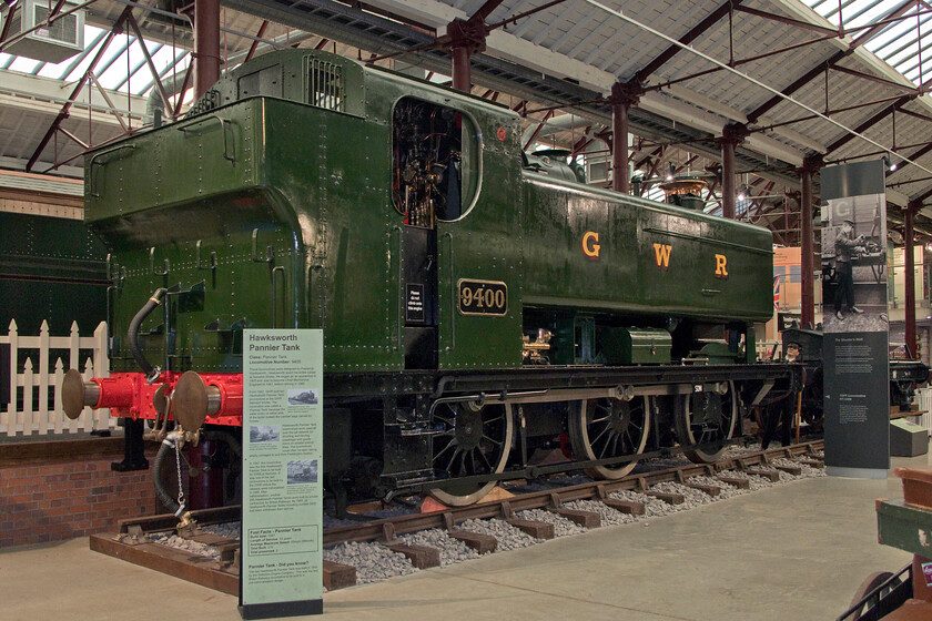 9400, on display, Steam museum, Swindon 
 Built on this spot, allocated to the adjacent depot for a number of years and then after withdrawal returning to the works to be prepared for preservation makes this a locomotive firmly rooted in Swindon! 9400 was a member of a sub-class of incredibly versatile and numerous locomotives collectively referred to as the Panniers after their water tank design that straddles the boiler. 9400 has not turned a wheel in steam since it was withdrawn and is unlikely to do so ever again but it remains a fine example of the class. 
 Keywords: 9400 on display, Steam museum Swindon Pannier tank