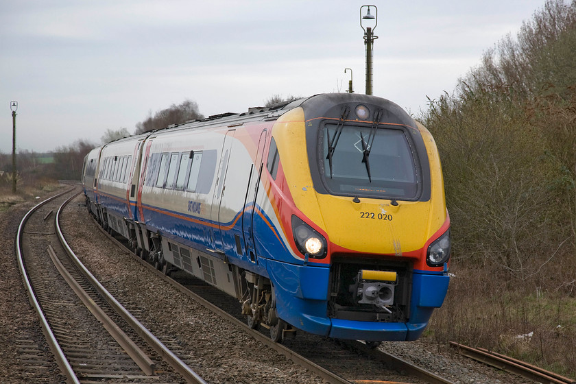 222020, EM 09.29 London St. Pancras-Nottingham (1D19), Kettering station 
 222020 'City of Derby' slows for its stop at Kettering working the 1D19 09.29 St. Pancras to Nottingham. This rather anonymous photograph makes a fascinating comparison to one that I took back in 1978. Whilst the positioning is not quite the same (I had walked off the end of platform one then) and the trees have grown the lamp posts still stand ready to illuminate the once extensive yards and sidings that have now been removed, indeed I was standing just in front of the lamp post emerging from the roof of the Meridian, see.... https://www.ontheupfast.com/p/21936chg/29663552804/kettering-station-signal-box-curve 
 Keywords: 222020 09.29 London St. Pancras-Nottingham 1D19 Kettering station East Midlands Train Meridian City of Derby