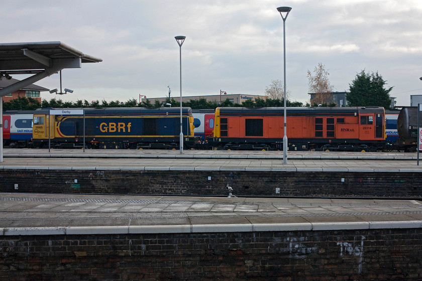 20905 & 20314, stabled, Derby station 
 The second pair of class 20s at Derby on this cold and bleak morning sit stabled at the southern end of the station. 20905 looks reasonable in its GBRF livery but I am not at all convinced by 20314 in its Harry Needle colour scheme? 
 Keywords: 20905 20314 stabled, Derby station