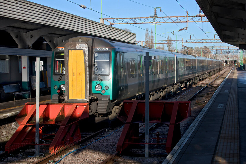 350369, LN 10.37 Northampton-Birmingham New Street (2Y53, 5L), Northapton station 
 The first train of our journey from Northampton to Frome waits in the crisp winter sunshine prior to its departure. My wife and I travelled on 350369 working the 10.37 service to Birmingham arriving just five minutes late. Despite the delayed arrival, we had a generous connection so we still managed a coffee at New Street. 
 Keywords: 350369 10.37 Northampton-Birmingham New Street 2Y53 Northampton station London Northwestern Desiro