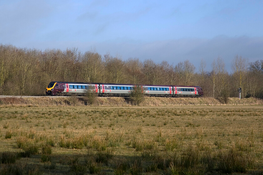 Class 221, XC 06.48 Derby-Reading, King's Sutton SP498354 
 An unidentified Class 221 Voyager passes just south of King's Sutton at speed working the 06.48 Derby to Reading CrossCountry service. Notice the darkening of the sky that was nothing compared with what was going on behind me heralding a very wet day to come! Whilst I am in Northamptonshire the county boundary with Oxfordshire is immediately behind the embankment following the trees that themselves follow the meandering route of the River Cherwell. 
 Keywords: Class 221 06.48 Derby-Reading King's Sutton SP498354 CrossCountry Voayger