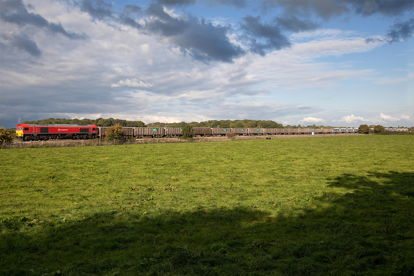 59204, 12.39 Acton-Merehead (7C77), Berkley ST808497 
 In glorious afternoon sunshine and under a big and dramatic autumnal sky, 59204 brings the 12.39 Acton to Merehead empty stone train past Berkley near Frome. 59205 was a member of the last batch that entered service in October 1995. After twenty years of hard service on these stone trains, it still looks good in its new DB red livery. 
 Keywords: 59204 12.39 Acton-Merehead 7C77 Berkley ST808497