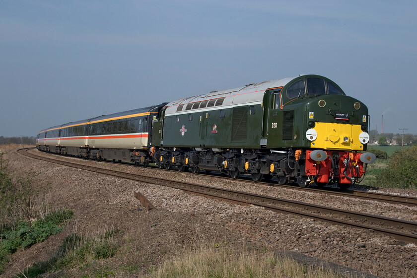 D213, outward leg of The Norfolk Coast Express, 06.19 Manchester Piccadilly-Great Yarmouth (1Z75 4L), Harts Drove crossing TL273962 
 Looking absolutely superb in the bright spring sunshine D213 'Andania' leads The North Norfolk Express charter past Harts Drove lane near the Fenland village of Whittlesey. The charter left Manchester at 06.19 taking an interesting route via the Hope Valley led all the way by the Class Forty Appeal's locomotive. Wearing its British Railways green livery it does not quite match the InterCity Executive livery of the stock but it would be churlish to complain about the lack of matching stock and locomotive! 
 Keywords: D213 The Norfolk Coast Express 06.19 Manchester Piccadilly-Great Yarmouth 1Z75 Harts Drove crossing TL273962 Andania