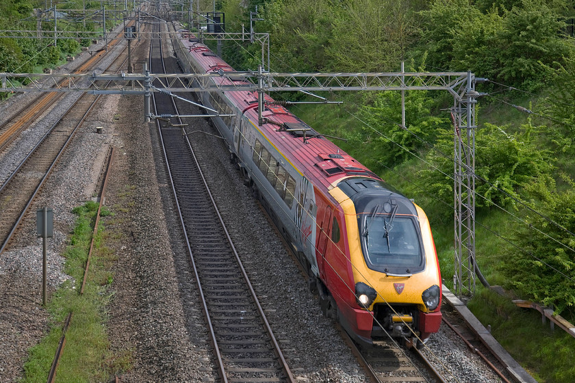 Class 221, VT 15.20 London Euston-Birmingham New Street (9G30), Victoria bridge 
 An unidentified Class 221 roars past Victoria bridge just south of Roade in Northamptonshire forming the 15.20 Euston to Birmingham New Street. Where is the sense in running a diesel between London and Birmingham under fully electrified and energised 25kV wiring? 
 Keywords: Class 221 15.20 London Euston-Birmingham New Street 9G30 Victoria bridge Voyager