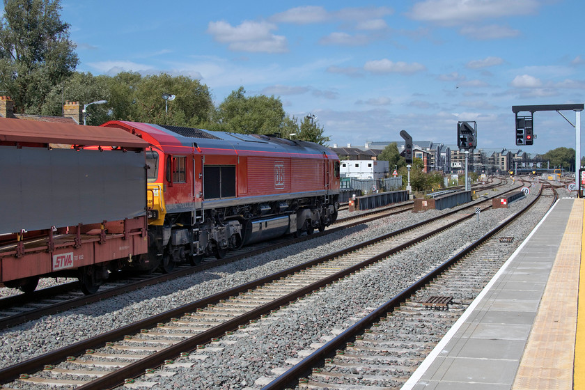 66009, 10.34 Southampton Eastern Docks-Halewood (6M48), Oxford station 
 66009 is a photographic 'cop' so I was pleased to see it waiting in the centre road at Oxford station even if I was the wrong side for the sun! It is waiting for the road north with the 10.34 Southampton Eastern Docks to Halewood empty cartics. It seems a bit of a waste hauling a train of fresh air all that distance but I suppose there is not a lot else can be done considering that it has earned its keep doing the journey south fully loaded with cars for export. Despite all the improvements at Oxford, it remains chronically overcrowded and is a major pinch-point on the network for control to try and manage. 
 Keywords: 66009 10.34 Southampton Eastern Docks-Halewood Oxford station