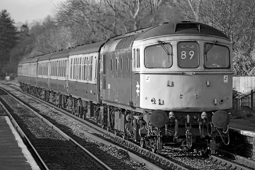 Class 33, unidentified Cardiff Central-Portsmouth Harbour working, Bradford-on-Avon station 
 An unidentified Class 33 approaches Bradford-on-Avon station working a Cardiff to Portsmouth Harbour service made up of a mixture of Mk. I and Mk. II stock The locomotive is displaying the correct 89 headcode for this service. In lighting such as this Ilford FP4 film was able to reproduce an exceptionally wide tonal range and also scans very well today using modern equipment as demonstrated in this image. 
 Keywords: Class 33 unidentified Cardiff Central-Portsmouth Harbour working Bradford-on-Avon station