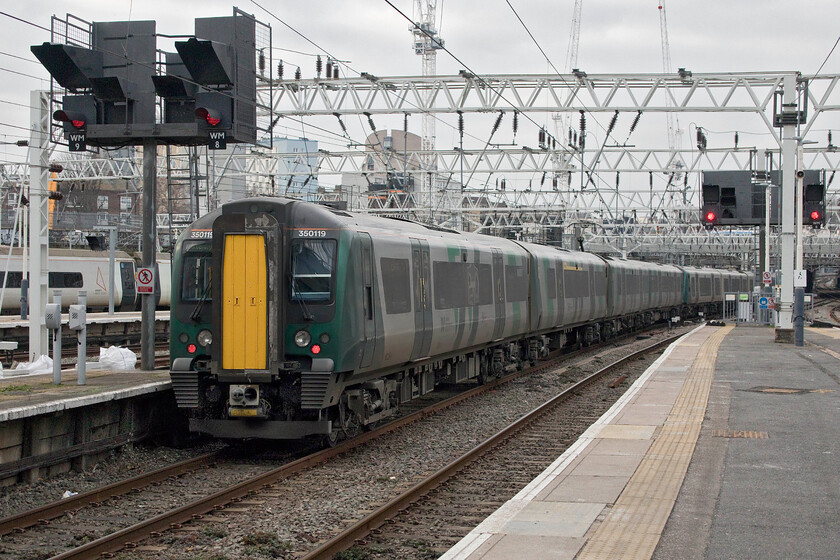 350119, LN 14.39 London Euston-Milton Keynes Central (2K37, RT), London Euston station 
 At a dull and grey London Euston, 350119 leaves working the 14.39 stopper service to Milton Keynes. Despite leaving over fifteen minutes before our train left Euston we still managed to pass this train before exiting the suburbs of the capital! 
 Keywords: 350119 14.39 London Euston-Milton Keynes Central 2K37 London Euston station London Northwestern Railway