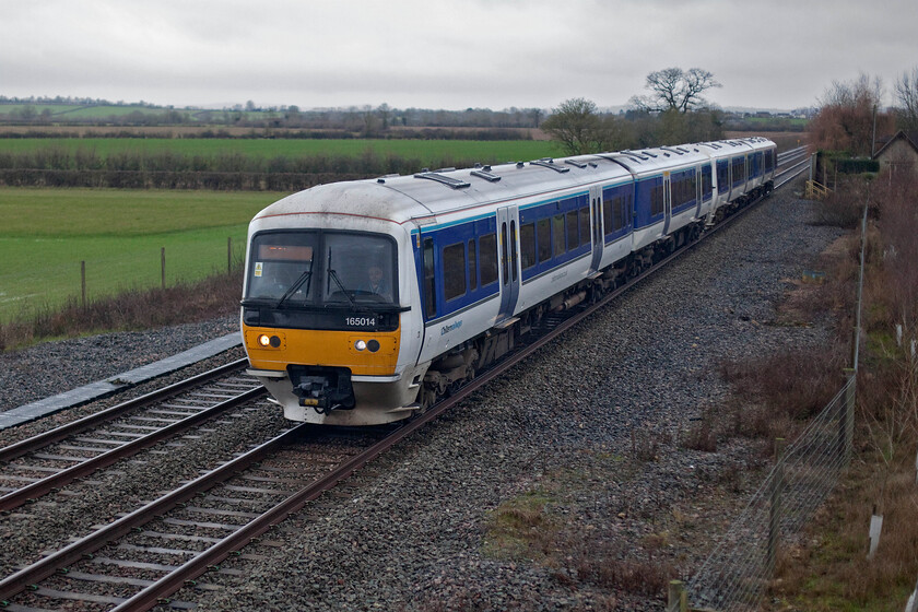 165014 & 165002, CH 09.11 Oxford-London Marylebone (1Y17, RT), Oddington SP542160 
 Less than an hour after the previous photograph was taken at Heyford station the lighting has improved considerably. Whilst it is far from perfect at least I have been able to turn the ISO down to something more sensible! Chiltern's 165014 passes Oddington between Oxford and Bicester working the 09.11 Oxford to Marylebone service. The wooden structure seen to the right of the rear of the train marks the spot where the former level crossing crossed this line prior to its huge expansion and modernisation that led to the construction of the large overbridge where I am standing. 
 Keywords: 165014 165002 09.11 Oxford-London Marylebone 1Y17 Oddington SP542160 Chiltern Railways