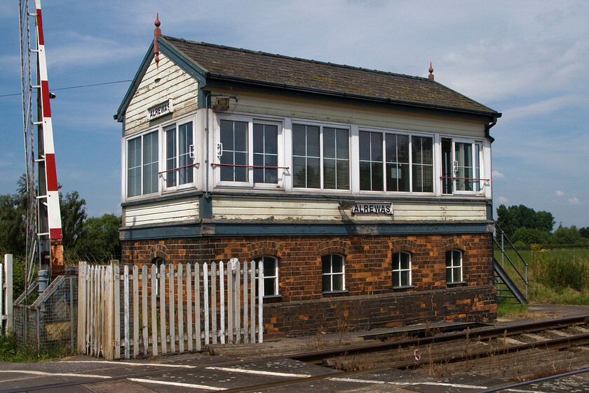 Alrewas signal box (L&NWR, 1899) 
 Part form its replacement windows and galvanised steel steps Alrewas signal box looks typically London and North Western Railway in origin. The company built many of these Type 4 boxes with this particular example just a short distance from Wichnor Junction where the line joins the Midland route from Birmingham to Derby. This box and its counterpart at Lichfield Trent Valley control a short section of absolute block of just over five miles. Not many trains traverse this route with them all being freight unless there are diversions or charters eager to get some rare track! 
 Keywords: Alrewas signal box