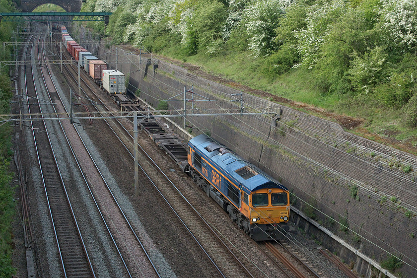 66735, 14.18 Trafford Park-Felixstowe North (4L18, 4E), Roade cutting 
 Seen earlier in the day.... https://www.ontheupfast.com/p/21936chg/29000436004/x66735-03-10-felixstowe-north-trafford 66735 'Peterborough United' now returns south again leading the 14.18 Trafford Park to Felixstowe 4L18 Freightliner. The train is seen from Muddy Lane bridge that spans Roade cutting and was taken during my 'extended' COVID-19 walk to buy some provisions at the local garage. 
 Keywords: 66735 14.18 Trafford Park-Felixstowe North 4L18, Roade cutting