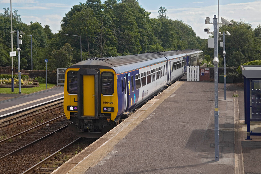 156496 & 156487, NT 09.02 Carlisle-Barrow-in-Furness (2C46, 24L), Wigton station 
 In the past, judging by the heritage information and photographs on display at Wigton station, there were two rather grand buildings on each platform. Today passengers make do with a couple of bus shelter type structures to protect them from the worst of the Cumbrian coast weather! 156496 leads 156487 into the station working the 09.02 Carlisle to Barrow-in-Furness Northern service with just one passenger joining the train who was just out of sight to the right. 
 Keywords: 156496 156487 09.02 Carlisle-Barrow-in-Furness 2C46 Wigton station Northern