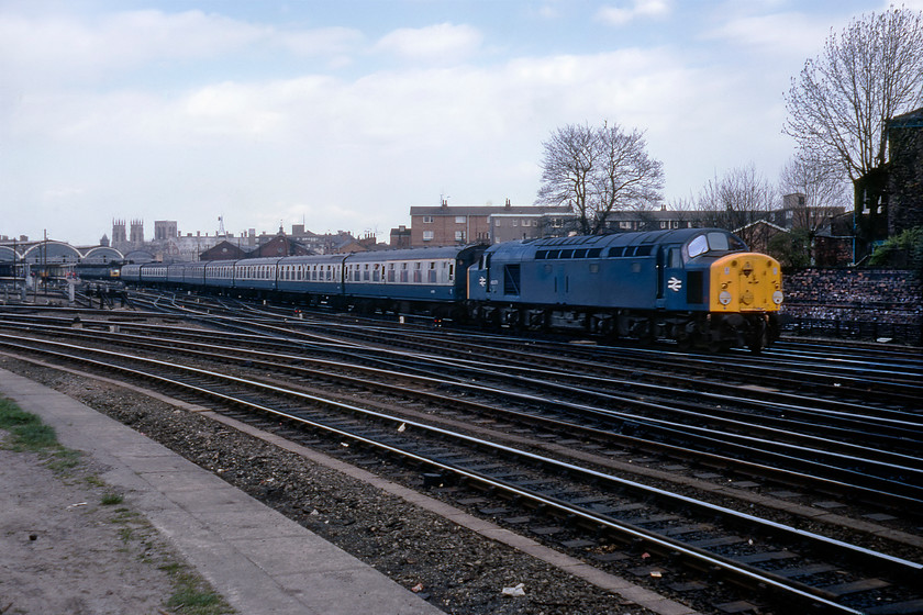 40078, unidentified Newcastle-London King's Cross relief, Holgate Bridge 
 Taken from under Holgate bridge, York's fine station and Minster can be seen in the background. 40078 leads a rake of eight Mk.I coaches away south with a Newcastle to King's Cross relief. However, there appears to be some debate over this working as the 40 Motherlist site has this down as the 1E70 10.06 Dundee to King's Cross (relief as far as Edinburgh Waverley). Either way, this was in the days when BR had the flexibility to put a relief service together at short notice to alleviate a problem and to support the travelling public - unlike today's totally inflexible railway. It was also a time when enthusiasts could get close to the tracks at Holgate bridge to undertake some serious spotting and, in my case, take some interesting photographs. The tracks curving away to the left are the York avoiding lines.

There is an audio recording of this event on my youtube channel, see.... https://youtu.be/__libtJvkW4 
 Keywords: 40078 Newcastle-London King's Cross relief Holgate Bridge