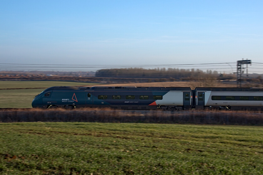 390118, VT 07.20 London Euston-Manchester Piccadilly (1H09, 17L), Milton crossing 
 A pan shot of 390118 as it heads north working the 07.20 Euston to Manchester Piccadilly service as it passes Milton crossing between Roade and Blisworth. Unfortunately, the early morning sun had not quite come round far enough to illuminate the side of the train 
 Keywords: 390118 07.20 London Euston-Manchester Piccadilly 1H09 Milton crossing