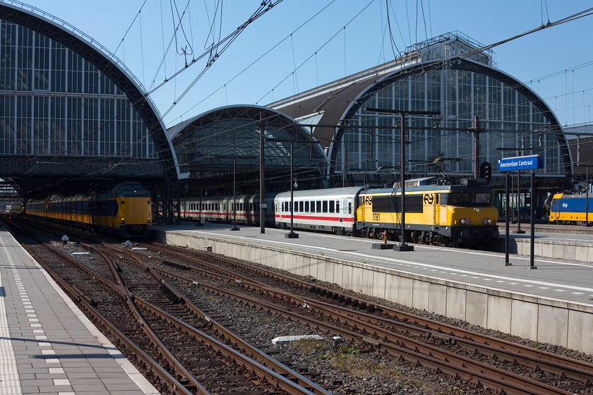 1761, 17.00 Amsterdam Central Hannover Hbf (Int. 241) & ICM 17.03 Amsterdam Central-Amersfoort (IC 1561), Amsterdam Central station 
 On a beautiful late afternoon 1761 leaves Amsertdam Central station with the 17.00 cross-border international to Hannover. Hauled by a Nederlandse Spoorwege electric locomotives of some 6 200hp, they were built by Alstom in the early 1990s and are based on the SNCF 1600s of the 1980s. There were 81 built but some have succumbed to, for example fire! An IC3 stands to the left waiting to leave for Amersfoort. 
 Keywords: 1761, 17.00 Amsterdam Central Hannover Hbf (Int. 241) & ICM 17.03 Amsterdam Central-Amersfoort (IC 1561), Amsterdam Central station