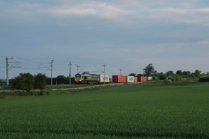 66566, 01.09 Ditton-Felixstowe North (4L41, 5L), Milton Malsor SP740557 
 Just a few minutes after the previous southbound Freightliner had passed 66566 appeared at Milton Malsor leading the 4L41 01.09 Ditton to Felixstowe service. In the short time between the trains, the sun had gone behind a bank of cloud that totally changed the lighting characteristics. Now being ten minutes to six it really felt like it was time to head home for some breakfast! 
 Keywords: 66566 01.09 Ditton-Felixstowe North 4L41 Milton Malsor SP740557 Freightliner