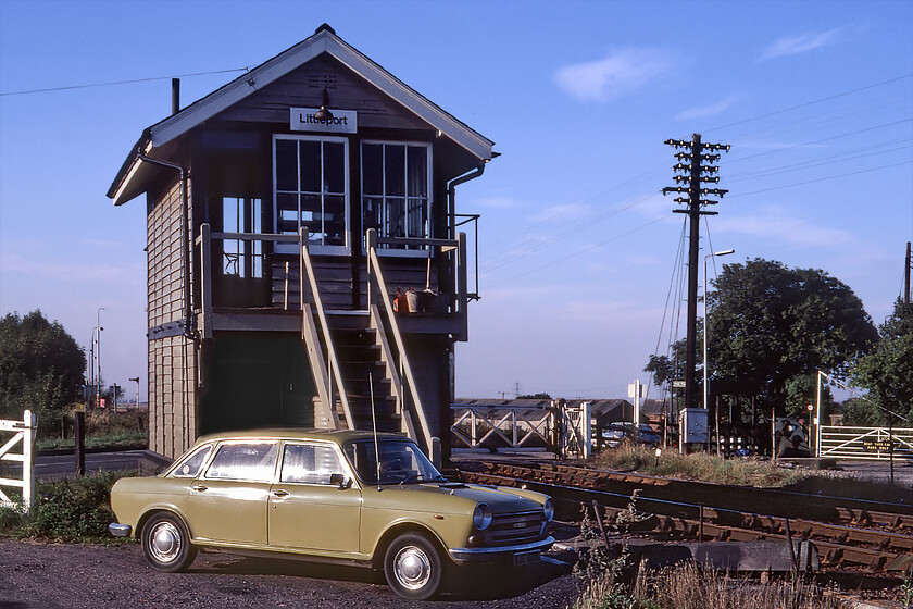 Littleport signal box (GE, 1880) 
 Littleport signal box is seen in the evening sunshine looking very smart rather like the signalmans 'K' registration facelift Morris 1800 Landcrab in what I believe to be laughably called Limeflower! The box is a Great Eastern Type 2 box dating from 1880 that was in use until 2021 when control moved to the Cambridge regional signalling centre that included the automation of the level crossing barriers. In this view, the manually operated gates can be seen behind the box and the station just beyond to the left. However, on my most recent visit to the area in 2023, the box was still in use but looking particularly precarious, see.... https://www.ontheupfast.com/p/21936chg/30041446459/littleport-signal-box-ge-great-eastern 
 Keywords: Littleport signal box GE Great Eastern