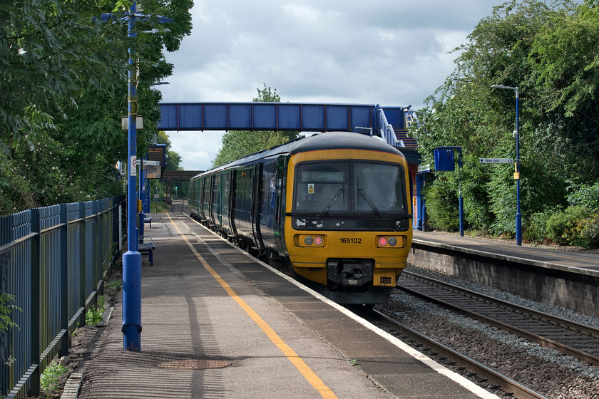 165102, GW 09.09 Banbury-Dictot Parkway (2V21, 2L), King`s Sutton station 
 In a welcome burst of sunshine, Great Western's 165102 pauses at King's Sutton station working the 09.09 Banbury to Didcot Parkway service. Since the new timetable was introduced this return shuttle service operates extends to Didcot throughout the day. This route is as far north as Great Western operate with Banbury feeling a little like an outpost to the operator! 
 Keywords: 165102 09.09 Banbury-Dictot Parkway 2V21 King`s Sutton station