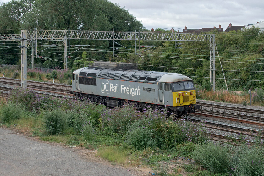 56091, 08.02 Willesden DC Sidings-Caddesden (0Z56, 2L), site of Roade station 
 Allotted the reporting number 1Z56 I suspected that the 08.02 Willesden to Cahaddesden (Derby) light engine move may well be a Grid! I was right, running bang-on-time 56091 'Driver Wayne Gaskell' passes the site of Roade station on the down slow line. Dating from June 1981 the Class 56 was one of the later built Doncaster locomotives hence its survival when compared to the Romanian-built examples most it which rusted away into an oblivion! 
 Keywords: 56091 08.02 Willesden DC Sidings-Caddesden 0Z56 site of Roade station Driver Wayne Gaskell