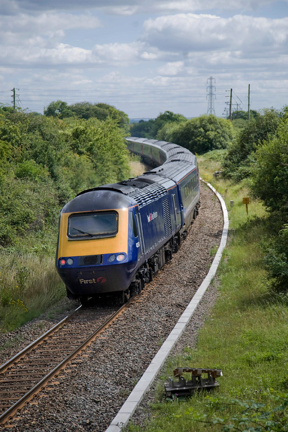 43193, GW 13.00 London Paddington-Bristol Temple Meads (1C15), diverted because of electrification work in Box tunnel, Thingley Junction 
 43193 at the back of the 13.00 Paddington to Bristol service disappears around the curve of track towards Melksham and Trowbridge diverted off the GWML due to engineering works in Box tunnel. The short eight miles stretch of line was singled in 1967 following a steady rundown by British Railways and closure of intermediate stations. It was muted for complete closure with the north spur at Bradford Junction removed in 1990. However, in recent years it has undergone somewhat of a renaissance with Melsksam station reopening and a regular through service in operation. It also carries a fair amount of freight and could re-doubling be just around the corner again? 
 Keywords: 43193 13.00 London Paddington-Bristol Temple Meads 1C15 diverted because of electrification work in Box tunnel, Thingley Junction First Great Western HST