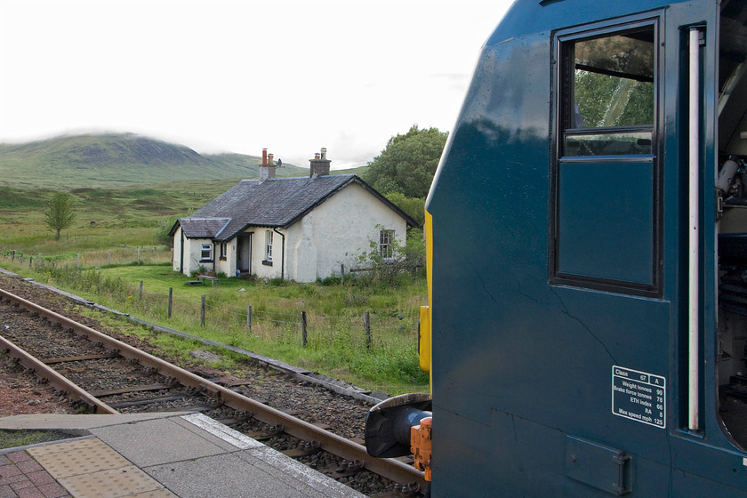 67004, CS 21.16 London Euston-Inverness, Fort William & Aberdeen sleeper (1S25 & 1Y11) & Renton Cottage, Rannoch station 
 I stayed in Renton Cottage located off the platform end at Rannoch station with friends a couple of times taking winter breaks a few years ago. When we were there, our morning peace and quiet was broken by Class 37s on the sleeper and freight services rather than 67004 'Cairn Gorm' as seen here. Renton Cottage was built for James Renton who was one of the directors of the West Highland Railway who put a substantial amount of his personal fortune into the company in order for the railway to be completed in 1893. The technical problems of the constructing the line across Rannoch Moor nearly bankrupted him and the company costing an estimated one point one million pounds. There is a stone bust of James Renton carved into a huge lump of rock on the platform end at Rannoch station just to the left of where I am standing. 
 Keywords: 67004 21.16 London Euston-Inverness, Fort William Aberdeen sleeper 1S25 1Y11 Renton Cottage Rannoch station Caledonian Sleeper Cairn Gorm