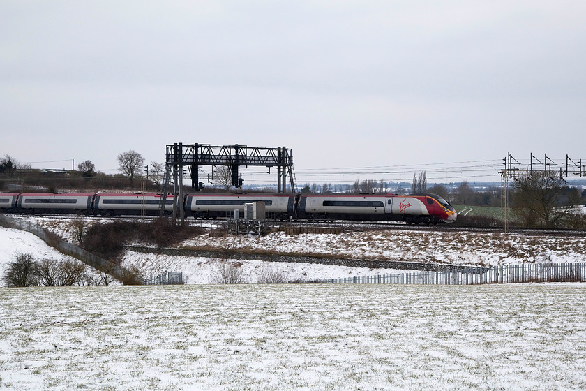 390141, VT 12.17 London Euston-Manchester (1H08, 1E), between Roade & Ashton 
 Virgin Trains' 12.17 London Euston to Manchester Piccadilly speeds through the snowy Northamptonshire countryside near Roade. The 11-car Pendolino is 390141 '	City of Chester'. 
 Keywords: 390141 1H08 between Roade & Ashton