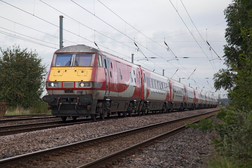 82102 & 91129, GR 05.48 Edinburgh Waverley-London Kings Cross (1E02, 1L),-East Road Crossing TL192415 
 DVT 82102 leads with 91129 providing the power at the rear as the 05.48 Edinburgh Waverley to London King's Cross. The 1E02 is seen racing past East Road level crossing, just south of Biggleswade, with just 38 miles of its 392 mile journey left to cover. 
 Keywords: 82102 91129 1E02 East Road Crossing TL192415