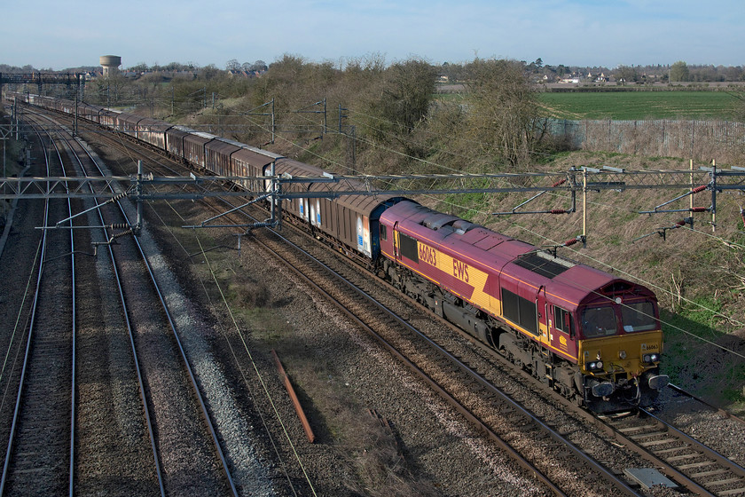 66063, 14.47 DIRFT-Dollands Moor (6M45, 112E), Victoria bridge 
 The daily 4M45 conveys a rake of empty IZA Cargowagon twins from Daventry back to Dollands Moor for onward travel through the Channel Tunnel. The balancing working brings bottled water from the continent back to Daventry for distribution throughout the UK. Dating from the mid-1980s, the IZAs are not the most attractive of wagons and they appear to be an easy target for graffiti vandals but they are eminently practical and I am surprised that we do not make better use of them here in the UK. 
 Keywords: 66063 14.47 DIRFT-Dollands Moor 6M45 Victoria bridge