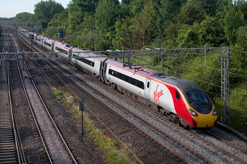 390107, VT 07.30 London Euston-Glasgow Central (1S52, 52L), Victoria Bridge 
 Running at fraction of the permitted line speed past Victoria Bridge, 390107 'Independence Day Resurgence' works the 1S52 07.30 London Euston to Glasgow Central. It was running on cautions all the way to Rugby as it was following a diverted Garston Freightliner working. This delay, and more problems further north, resulted in this service arriving into Glasgow some 52 minutes late. 
 Keywords: 390107 1S52 Victoria Bridge