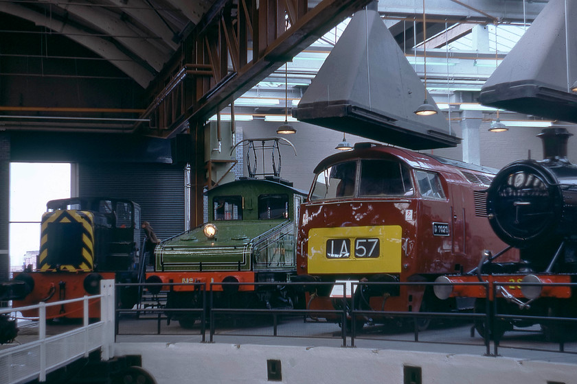 D2860, 26500, D1023 & 2818, on-display, NRM 
 No visit to York for a young enthusiast like myself in 1979 would be complete without a going to the have look around the National Railway Museum. Then it had just one main hall and was a fraction of the size it is today. Here, gathered around the turntable is a class 02 0-4-0 Yorkshire Engine Company shunter, number D2860, that only completed a paltry nine years in service before withdrawal in 1970. Next to the shunter is Bo-Bo British Thomson-Houston shunter of 1902 vintage number 26500, this did an amazing sixty-two years in service. From more modern times, D1023 'Western Fusilier' had only been withdrawn for just over two years and looked very smart in its maroon livery. Finally, putting in an appearance to the right is Churchward designed 2-8-0 2818. so, then the oldest locomotive in the line-up is the electric that pre-dates the steam by three years! 
 Keywords: D2860 26500 D1023 2818 on-display NRM