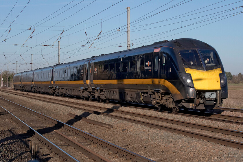 180106, GC 09.54 Sunderland-London King's Cross (1A64, 31L), Holme Green crossing TL192426 
 Now looking a little tatty and tired Grand Central's 180106 passes Holme Green foot/farm crossing just south of Biggleswade. The unit is working the 1A64 09.54 Sunderland to King's Cross service that is just forty miles from completing its journey. Being able to get close to trains on flat crossings but still being safe is getting a rare thing now on the network so get these types of photographs whilst you still can! 
 Keywords: 180106 09.54 Sunderland-London King's Cross 1A64 Holme Green crossing TL192426 GRand central