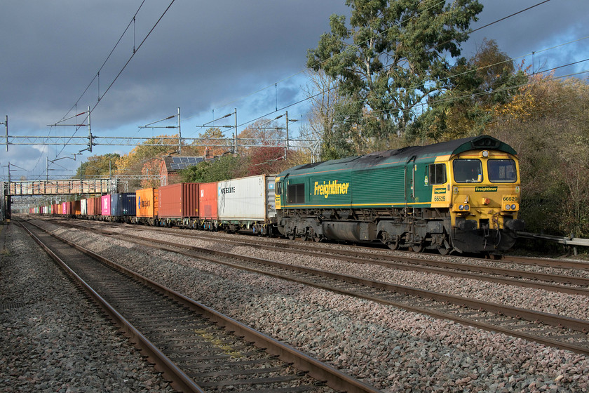 66529, 12.16 Lawley Street-London Gateway (4L46, 1L), Cathiron SP4667783 
 Under a dramatic sky, 66529 brings the 4L46 Lawley Street to London Gateway along the up slow line at Cathiron. I have photographed at this well known and popular spot a number of times but this is the first time that I have been able to use my Canon compact with its flip-out screen through the fencing affording a different perspective. I appreciate that it is a rather standard three-quarter view but I love the uncluttered line stretching off in the distance and the lovely lighting. 
 Keywords: 66529, 12.16 Lawley Street-London Gateway (4L46, 1L), Cathiron SP4667783 Freightliner