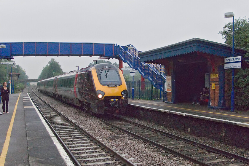 Class 220, XC 09.14 Southampton Central-Manchester Piccadilly, King's Sutton station 
 The only remnant of the original station at King's Sutton is the former GWR over-engineered (as was their style) waiting shelter on the down platform. The footbridge is a relatively new installation being built in 2005 as a result of the closure of the barrow crossing seen in the previous photograph. A CrossCountry Class 220 shatters the peace of the station working the 09.14 Southampton to Manchester service. 
 Keywords: Class 220 09.14 Southampton Central-Manchester Piccadilly King's Sutton station CrossCountry Voyager