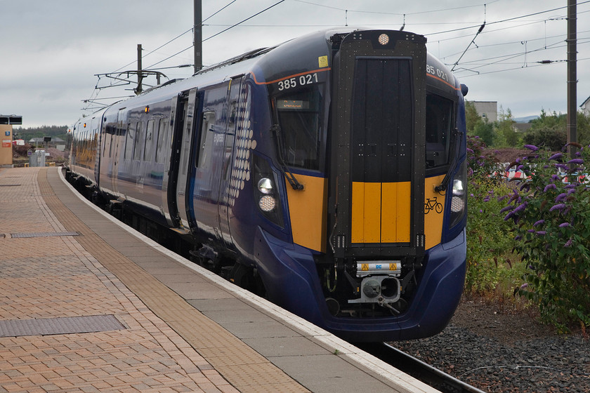 385021, SR 13.08 Dunbar-Edinburgh Waverley (2D97, RT), Dunbar station 
 385021 waits at the single platform at Dunbar station with the 13.08 to Edinburgh Waverley. The platform is bi-directional with the ECML main lines off to the right of this photograph behind the buddleia. This was to be the last Scotrail train that we would see on our tour and this is as far southeast as they operate. 
 Keywords: 385021 13.08 Dunbar-Edinburgh Waverley 2D97 Dunbar station