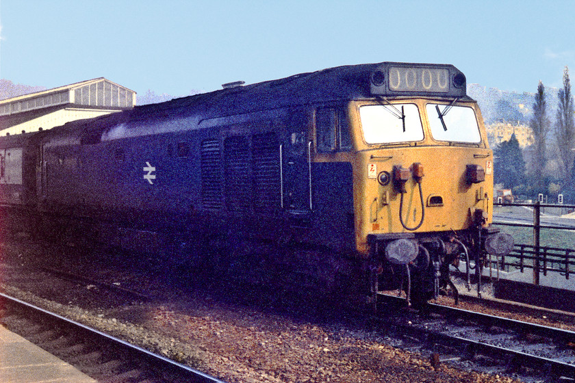 Class 50, unidentified down working, Bath Spa station 
 A class 50 waits to leave Bath Spa with a down working for either Bristol Temple meads or Western-Super-mare. These trains were long having eleven or twelve coaches and the 50s would draw a fair way forward of the platform ramp in order that all of the stock was accommodated on the platform. The down platform was (and still is) also almost completely blind because of a very sharp curve. Even today, long trains often have three dispatchers because of this. 
 Keywords: Class 50 Bath Spa station