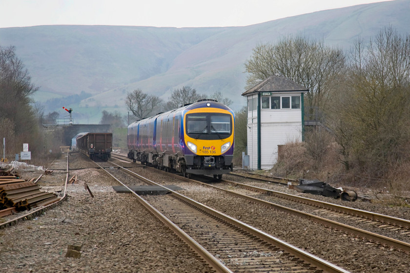 66031, 13.50 Heck Plassmoor-Peak Forest, Edale station & 185136, 14.55 Manchester Airport-Cleethorpes (1B82), Edale station 
 With a dramatic backdrop, TransPennine Express' 185136 passes Edale signal box forming the 1B82 14.55 manchester Airport to Cleethorpes. It has just passed the 13.00 Heck Plassmoor to Peak Forest empty wagons hauled by 66031. The village of Edale is probably best known as the starting point of the fabled Pennine Way long distance footpath. The actual start point is just a few minutes walk from the station. 
 Keywords: 66031 13.50 Heck Plassmoor-Peak Forest, Edale station 185136 14.55 Manchester Airport-Cleethorpes 1B82 Edale station