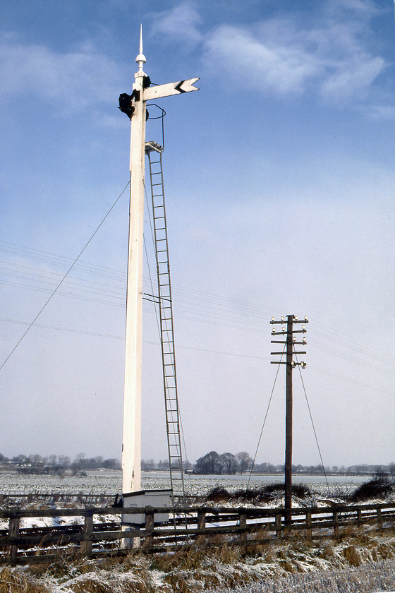 NER slotted post wooden distant semaphore, Haxby SE617588 
 A superb example of a rare NER slotted signal. This one looks to have been maintained in good condition by the S & T team was located just northeast of Haxby and was the signal box's up distant. Even by 1980, mechanical signals of this vintage were becoming unusual so Graham and I were pleased to discover this one still in use on the York to Scarborough line. 
 Keywords: NER slotted post wooden distant semaphore Haxby SE617588 North Eastern Railway